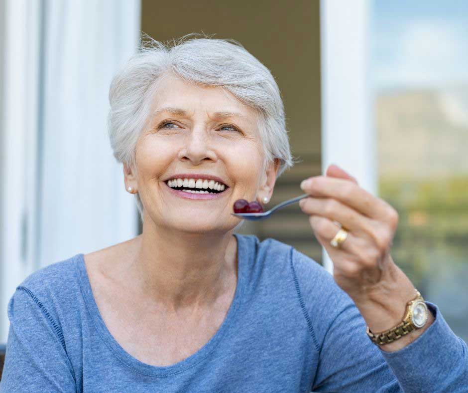 Senior eating healthy for blog post on nutritional needs of seniors